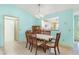 Dining area features a marble top table, seating for six, and decorative lighting at 735 Palma Dr, Lady Lake, FL 32159