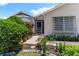 Well-manicured lawn and mature landscaping create a welcoming entrance to this home at 735 Palma Dr, Lady Lake, FL 32159