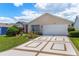 Charming single-story home with well-maintained landscaping and decorative driveway at 735 Palma Dr, Lady Lake, FL 32159
