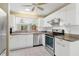 Bright kitchen featuring white cabinets, granite countertops, and stainless steel appliances at 735 Palma Dr, Lady Lake, FL 32159