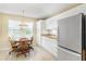 Bright eat-in kitchen nook with window, tile floors, and view of backyard at 735 Palma Dr, Lady Lake, FL 32159