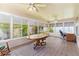 Bright sun room with tile floors, ceiling fans, and multiple windows for natural light and relaxing views at 735 Palma Dr, Lady Lake, FL 32159