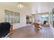 Cozy sun room with tiled floor, ceiling fan, wood desk, chairs, and lots of bright, natural light at 735 Palma Dr, Lady Lake, FL 32159