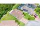 Aerial view of a home with green lawn and paved driveway at 780 Mystic Hill Ct, Kissimmee, FL 34759