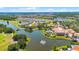 Lush landscape highlights this beautiful aerial view of the community, lakes, and golf course at 780 Mystic Hill Ct, Kissimmee, FL 34759