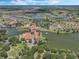 Expansive aerial view of the community, showcasing its picturesque lakes and charming clubhouse architecture at 780 Mystic Hill Ct, Kissimmee, FL 34759