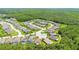 Aerial view of houses nestled within a residential community surrounded by green landscape at 780 Mystic Hill Ct, Kissimmee, FL 34759