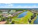 Beautiful aerial view of the community showing the golf course and homes along a large pond at 780 Mystic Hill Ct, Kissimmee, FL 34759