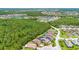 An aerial view of home and neighborhood with a view of the surrounding forest at 780 Mystic Hill Ct, Kissimmee, FL 34759
