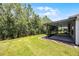 Lush backyard with a screened-in lanai, mature landscaping and well-kept lawn at 780 Mystic Hill Ct, Kissimmee, FL 34759