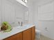 Bright powder room with modern white vanity, large mirror, and a tiled floor at 780 Mystic Hill Ct, Kissimmee, FL 34759
