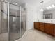 Bathroom features a tiled shower, double vanity, and neutral color palette at 780 Mystic Hill Ct, Kissimmee, FL 34759