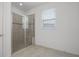 Bathroom featuring a glass enclosed shower with tiled walls at 780 Mystic Hill Ct, Kissimmee, FL 34759