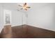 Large primary bedroom with hard wood floors, ceiling fan, and ensuite bathroom at 780 Mystic Hill Ct, Kissimmee, FL 34759