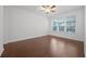 Bedroom with window, ceiling fan, and hardwood floors at 780 Mystic Hill Ct, Kissimmee, FL 34759