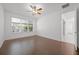 Bedroom features wood floors, a ceiling fan and ensuite bathroom at 780 Mystic Hill Ct, Kissimmee, FL 34759