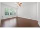 Bright bedroom features wood floors, large window, and a ceiling fan at 780 Mystic Hill Ct, Kissimmee, FL 34759