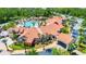 Aerial view of a large community center featuring a grand clubhouse, swimming pool, and meticulously landscaped grounds at 780 Mystic Hill Ct, Kissimmee, FL 34759