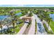 Picturesque community entrance with palm-lined streets and a charming gatehouse, set against the backdrop of a serene lake at 780 Mystic Hill Ct, Kissimmee, FL 34759