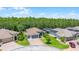 Two-car garage home featuring a brick driveway and lush landscaping at 780 Mystic Hill Ct, Kissimmee, FL 34759