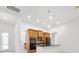 Modern kitchen featuring wood cabinetry, stainless steel appliances, granite countertops, and stylish pendant lighting at 780 Mystic Hill Ct, Kissimmee, FL 34759