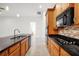 Modern kitchen with stainless steel sink, granite counters, and sleek black appliances at 780 Mystic Hill Ct, Kissimmee, FL 34759