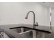 Close up of the stainless steel sink and black granite counter at 780 Mystic Hill Ct, Kissimmee, FL 34759