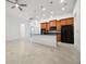 Open-concept kitchen with tile flooring, black appliances, and a spacious island perfect for entertaining at 780 Mystic Hill Ct, Kissimmee, FL 34759