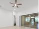 Bright living room with tile floors, ceiling fan, and sliding glass doors to the outside at 780 Mystic Hill Ct, Kissimmee, FL 34759