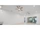 Spacious living room with tile flooring, ceiling fans, recessed lights, and sliding glass doors to the outside at 780 Mystic Hill Ct, Kissimmee, FL 34759