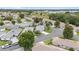 An aerial view showcases a neighborhood with well-maintained homes, green spaces, and tree-lined streets at 8608 Se 141St Street Rd, Summerfield, FL 34491