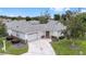 Charming single-story home with a well-manicured lawn, decorative driveway, and mature landscaping at 8608 Se 141St Street Rd, Summerfield, FL 34491