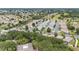 Expansive aerial view of a community featuring neatly arranged homes, mature trees, and a golf course at 8608 Se 141St Street Rd, Summerfield, FL 34491