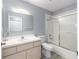 Bright bathroom with tub-shower combo, white vanity with modern sink, and coordinating commode at 8608 Se 141St Street Rd, Summerfield, FL 34491