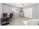 Sun-filled bedroom with wood-look floors, a desk, and a closet with mirrored doors at 8608 Se 141St Street Rd, Summerfield, FL 34491