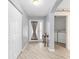 Foyer features wood-look floors, hall closet, and leads to laundry room at 8608 Se 141St Street Rd, Summerfield, FL 34491