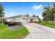 Charming home with a well-maintained lawn, an inviting front door, and an attached garage at 8608 Se 141St Street Rd, Summerfield, FL 34491