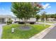 Well-maintained home featuring a lush green lawn, decorative shrubs, and mature flowering trees at 8608 Se 141St Street Rd, Summerfield, FL 34491