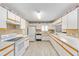 Spacious kitchen with white cabinets, modern appliances, and plenty of natural light at 8608 Se 141St Street Rd, Summerfield, FL 34491