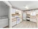 Bright kitchen featuring white appliances, ample counter space, and a convenient laundry area at 8608 Se 141St Street Rd, Summerfield, FL 34491