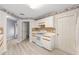 Bright kitchen shows white appliances and ample storage space in white cabinets with tan trim at 8608 Se 141St Street Rd, Summerfield, FL 34491