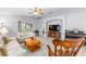 Bright living room with modern ceiling fan, neutral paint, and sliding glass door to the backyard at 8608 Se 141St Street Rd, Summerfield, FL 34491