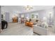 Spacious living room with wood-look floors flowing into the dining area and lots of natural light at 8608 Se 141St Street Rd, Summerfield, FL 34491