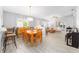 Open concept space with dining area and living area features natural light and wood-look floors at 8608 Se 141St Street Rd, Summerfield, FL 34491