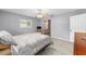 Airy main bedroom with neutral walls, ceiling fan, and access to an ensuite bathroom at 8608 Se 141St Street Rd, Summerfield, FL 34491