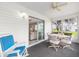 Enclosed patio with ceiling fan, table, chairs, and view to living area, for year-round enjoyment at 8608 Se 141St Street Rd, Summerfield, FL 34491