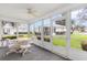 Enclosed porch featuring views of the manicured lawns and mature landscaping at 8608 Se 141St Street Rd, Summerfield, FL 34491