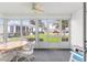 Enclosed patio featuring multiple windows for natural light and comfortable seating for entertaining at 8608 Se 141St Street Rd, Summerfield, FL 34491