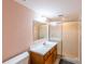 Well-lit bathroom featuring a walk-in shower and a modern vanity at 8705 Village Green Blvd, Clermont, FL 34711