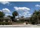 Well-maintained building with palm trees and lush landscaping under a sunny sky at 8705 Village Green Blvd, Clermont, FL 34711